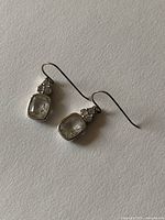 Both earrings laid flat showing overall design