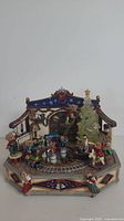 Front view showing entire music box with teddy bears, train track and Christmas tree
