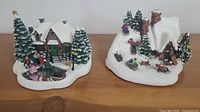 Both Thomas Kinkade musical boxes side by side