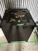 Front view of black lacquer chest showing inlaid crane scene on top