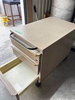 Cabinet angled view showing both drawers, casters and handle