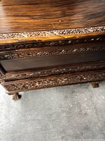 front view highlighting carved trim and drawer area