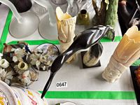 Overview of lot showing horn bird, two ivory cylindrical carvings, bust, coasters, floral spray