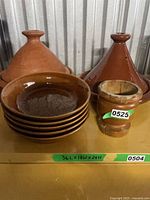 Two tagines, stack of six bowls, small mortar/cup