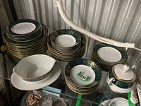 Stacks of dinner, salad plates, bowls, gravy boat, serving bowl, sugar bowl