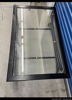 Top view showing rectangular glass inset and black frame