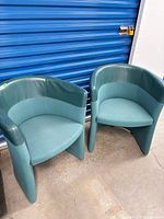 Pair of Kinnarps barrel-style chairs, front view