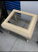 Top angle showing square coffee table base, ribbed sides, opening, brass-tone inlay