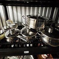 Full view of Stellar stainless cookware pieces on shelf