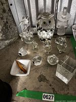 Group shot of all crystal items including owl, bears, flower, candle holders, bowl, vase