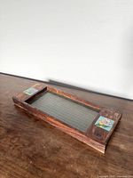 Top view showing full tray with wood frame, glass center, and both floral tiles