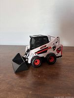 Front view showing bucket and wheel detail