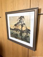 Framed Tom Thomson print hanging, full view