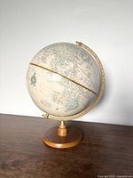 Full view of globe on wood base