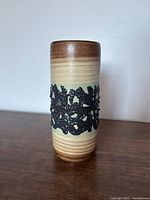 Full view of cylindrical vase showing glaze colours and relief band