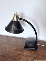 Full view of lamp showing gooseneck, shade, base