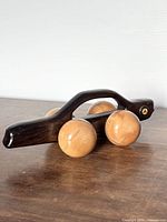 Full view of wooden car-shaped massager on tabletop
