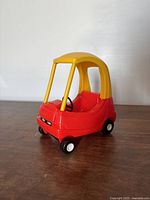 Front three-quarter view of miniature Cozy Coupe toy car