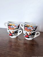 Two stacks of cups showing Roma graphic and Nuova Point style