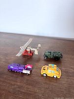 All four Transformers vehicles grouped together on tabletop