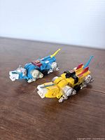 Blue and yellow Voltron lion figures angled side view