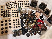 Wide view of entire button lot including cards, boxes, jars and loose buttons