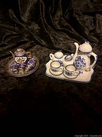 Overall view of both miniature tea sets together