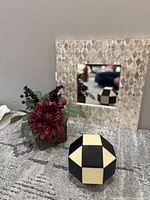 Group view of mirror, floral arrangement and geometric accent