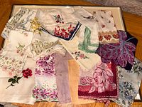 All 17 vintage floral embroidered handkerchiefs spread out for overview