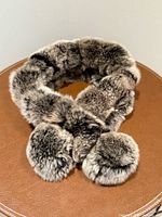 Full view of chinchilla fur neck warmer draped on table