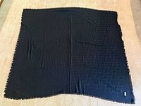 Full view of black Dior scarf laid flat