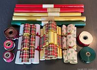 Overview showing wrapping paper rolls, crackers and ribbon spools