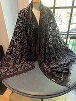 Shawl draped on mannequin showing full size and pattern