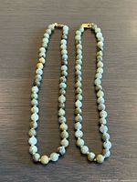 Both bead necklaces laid flat showing overall appearance and matching design