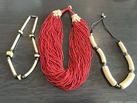 Front view of all three necklaces laid out