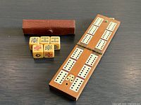 cribbage board open, dice, leather pouch