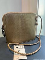 Front view of gold ribbed Cee Klein crossbody purse with braided strap