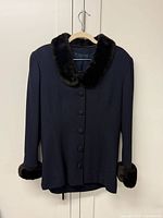 Front view of navy jacket with faux fur trim