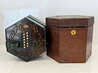 Concertina beside matching wooden case