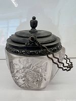 Full view of glass jam dish with silver-plated lid and handle attached