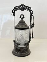 Full view of cruet set showing frame, jar, lid and tongs