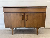 Front view of Jan Kuypers Imperial birch bar cabinet showing doors, pulls and legs