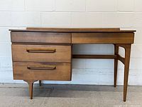 Front view of desk showing drawers, knee space and backsplash