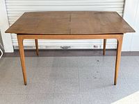 Top view of rectangular birch dining table, leaf inserted seam visible