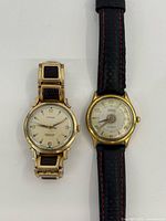 Both Cyma and Weber watches side by side