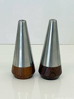 Front view of both conical shakers showing rosewood bases and stainless tops