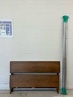 Full view of headboard, footboard stacked, steel rails upright