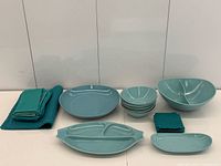 Full lot of ceramic dishes and blue textiles