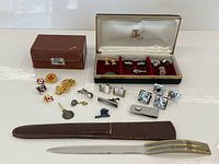 Full lot showing boxes, cufflinks, tie bars, pins and letter opener