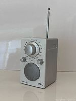 Front view showing tuner dial, speaker, controls, brand and model